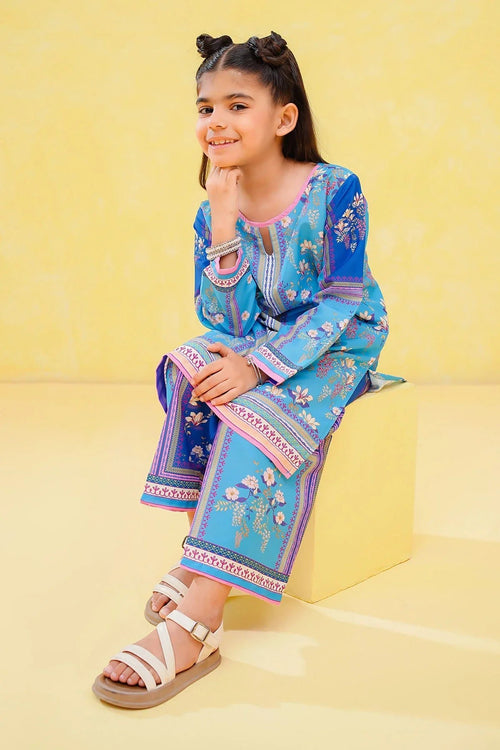 Girl in blue floral printed kids outfit with pink trim, sitting on yellow cube, perfect for trendy occasions