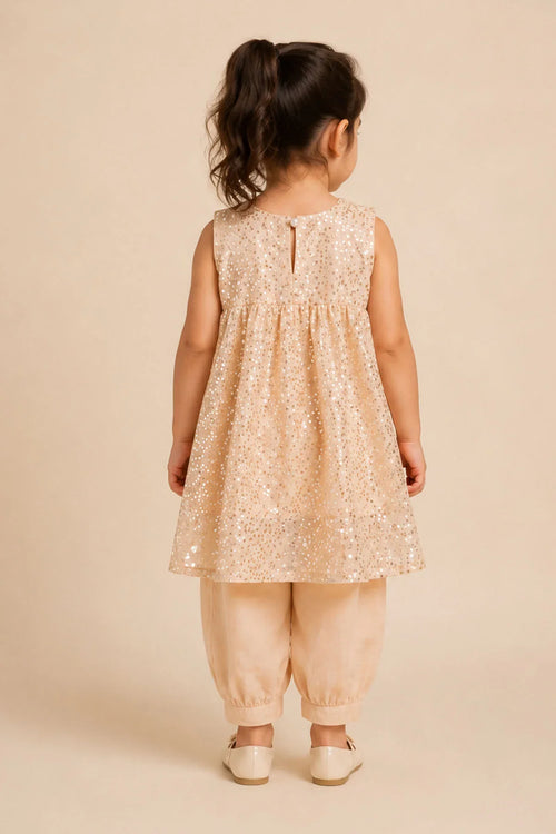 Toddler girl in beige sequin top and matching pants, back view, stylish kids fashion
