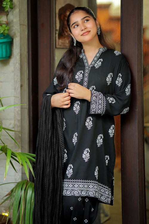 Black printed kurta with white floral embroidery, paired with matching pants and dupatta, perfect for casual wear.