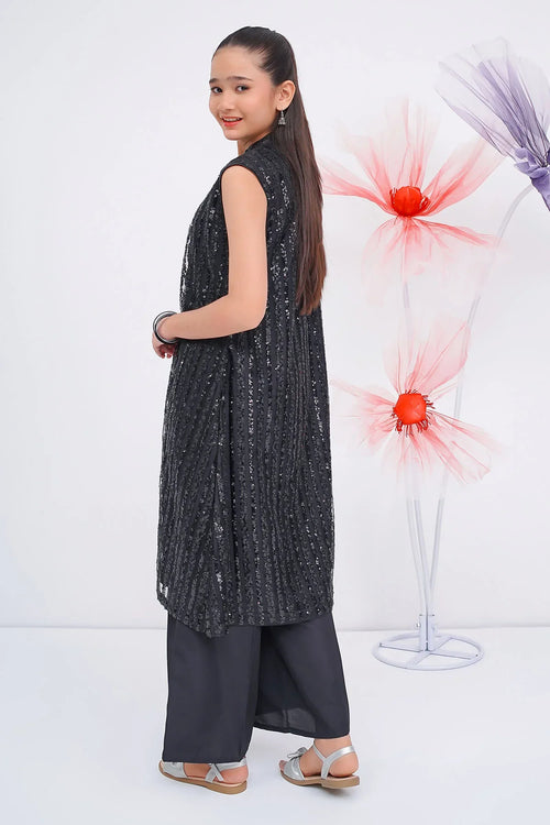 Girl wearing black sequin sleeveless tunic with wide pants, stylish kids fashion outfit