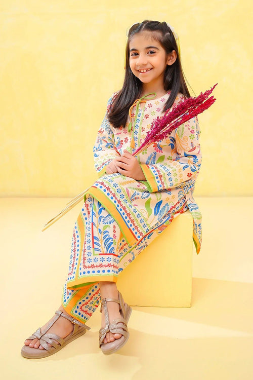Smiling girl in colorful floral kids outfit, sitting on yellow block with decorative stems, perfect for festive occasions.