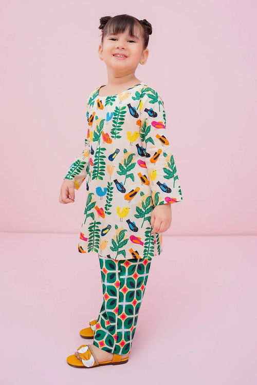 Girl wearing colorful bird and leaf print top with matching patterned pants, trendy kids fashion