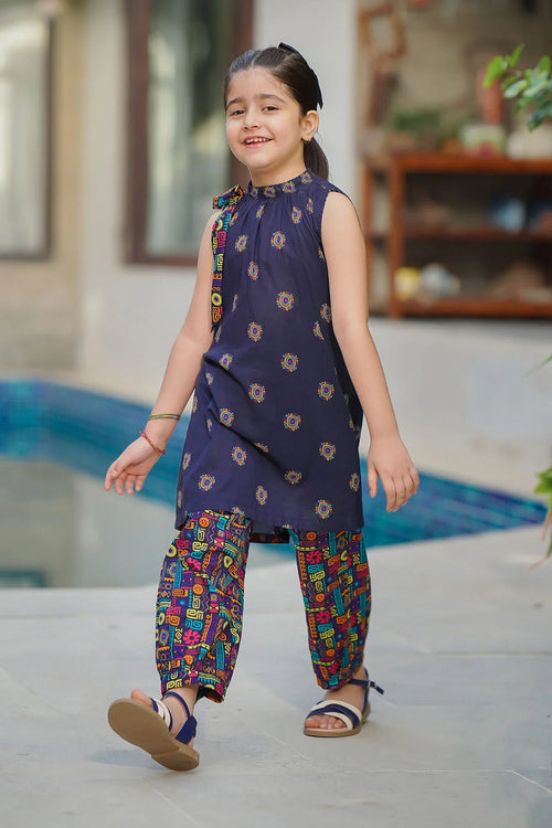 Girl in navy sleeveless top with colorful geometric print pants, stylish kids fashion for summer