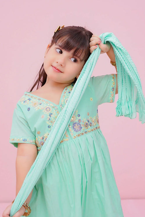 Little girl in mint green embroidered dress with matching dupatta, playful pose against pink background