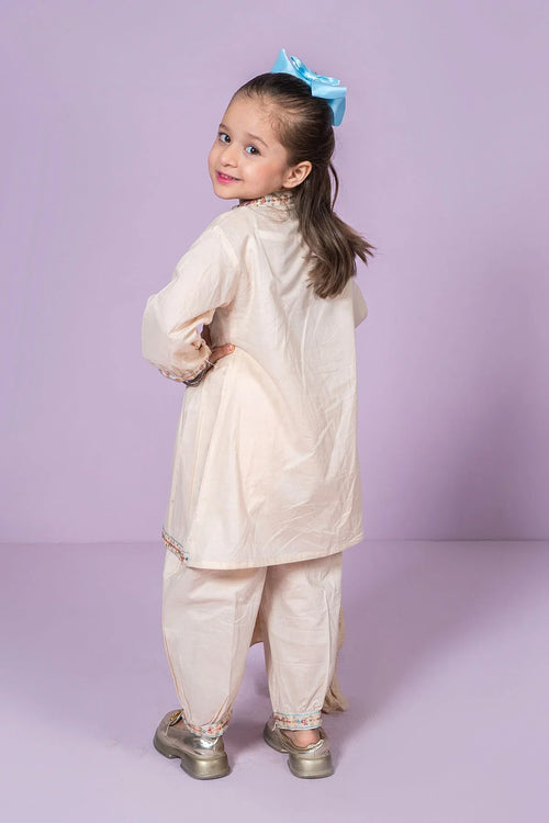 Little girl in cream embroidered kurta set with blue bow, stylish kids fashion for everyday wear