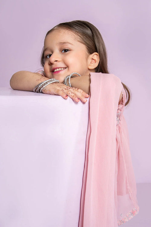 Smiling girl in pink traditional outfit with bangles and henna, perfect for festive occasions.