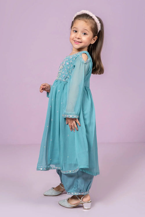 Little girl in turquoise embroidered dress with matching pants and sparkly shoes, perfect for festive occasions.