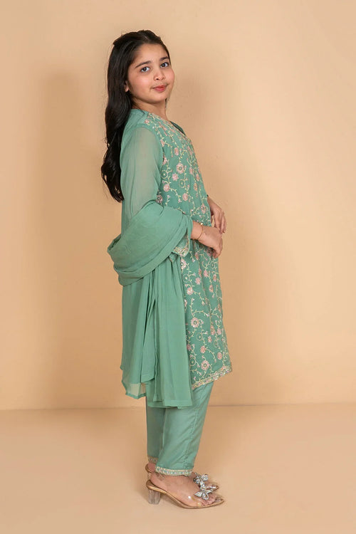 Girl in mint green embroidered kurta set with matching pants and sheer sleeves, perfect for festive occasions.