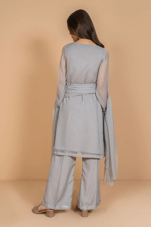 Grey women's palazzo suit with sheer sleeves and embellished hem, back view