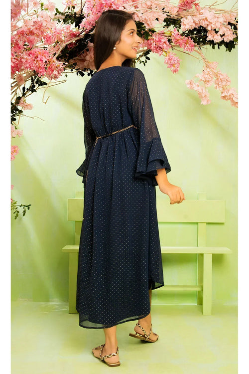 Navy polka dot dress with sheer sleeves and chain belt, styled for women's fashion