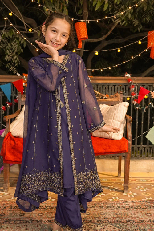 Girl in navy blue embroidered kurta with gold detailing, festive outdoor setting