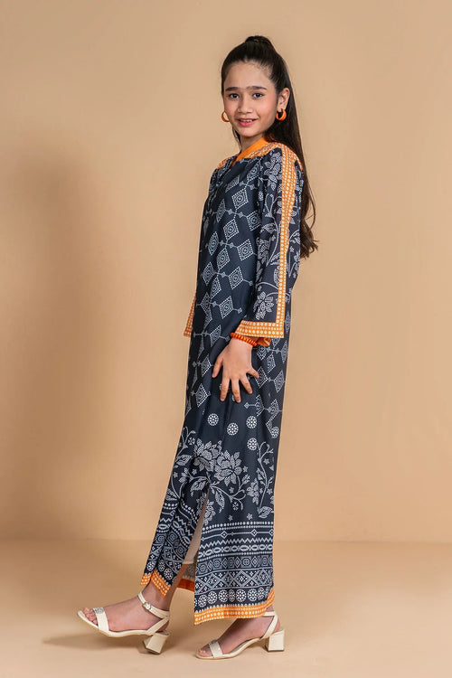 Girl wearing navy blue printed kurta with orange trim, paired with matching pants and white heels for casual wear