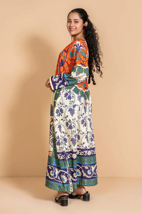 Woman in colorful floral print maxi dress with long sleeves, perfect for trendy women's fashion.