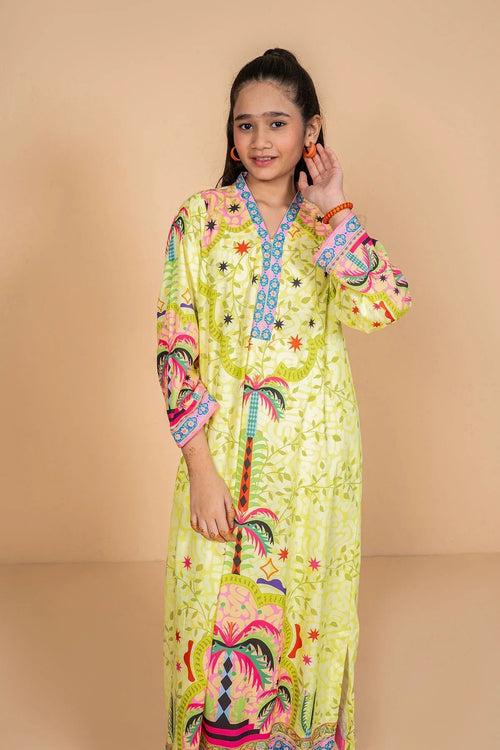 Girl wearing vibrant yellow printed kaftan with palm tree design, trendy kids fashion